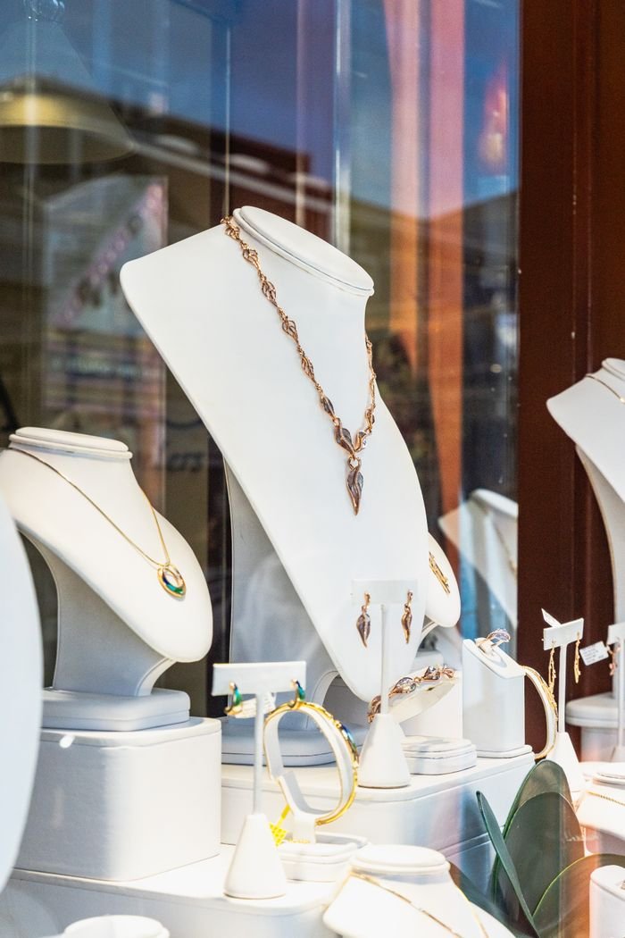 Luxurious jewelry showcased in a boutique window with elegant lighting.